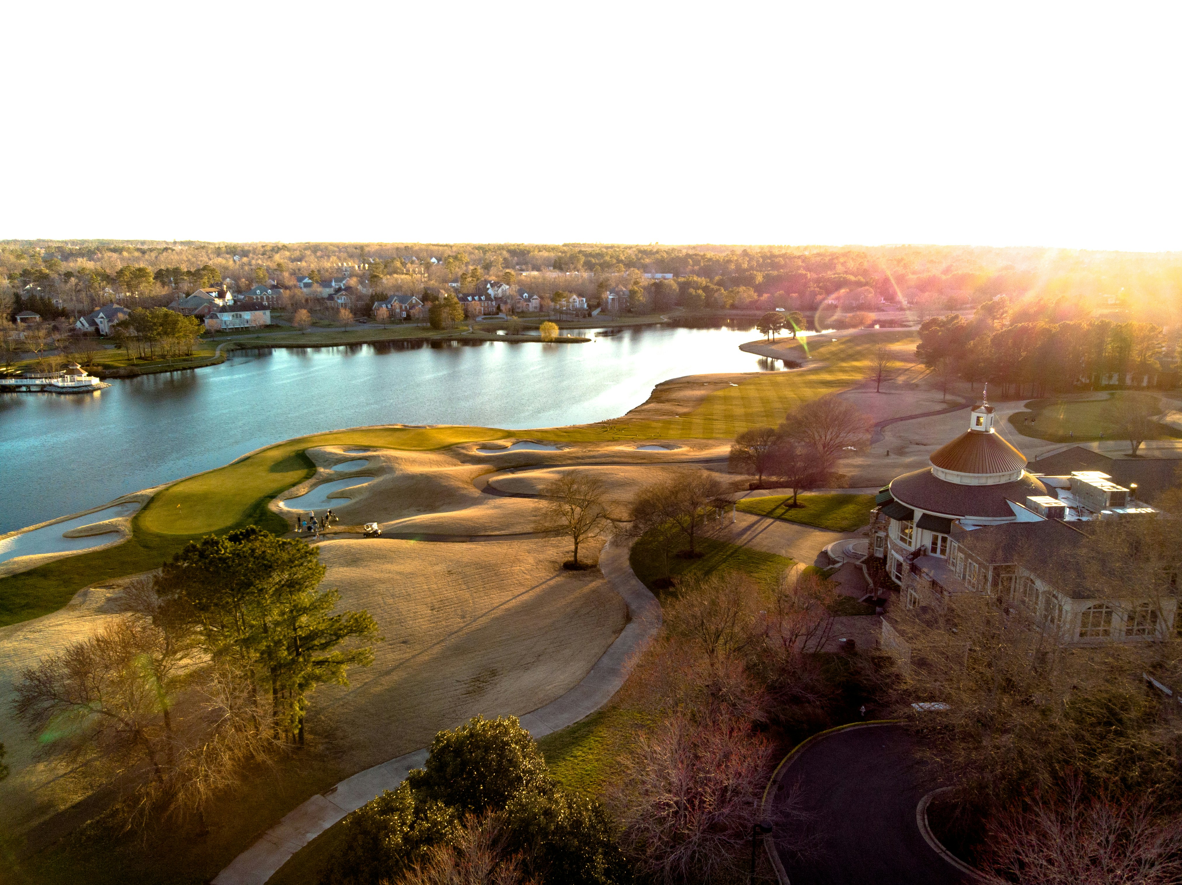 aerial view of green grass field near body of water during daytime